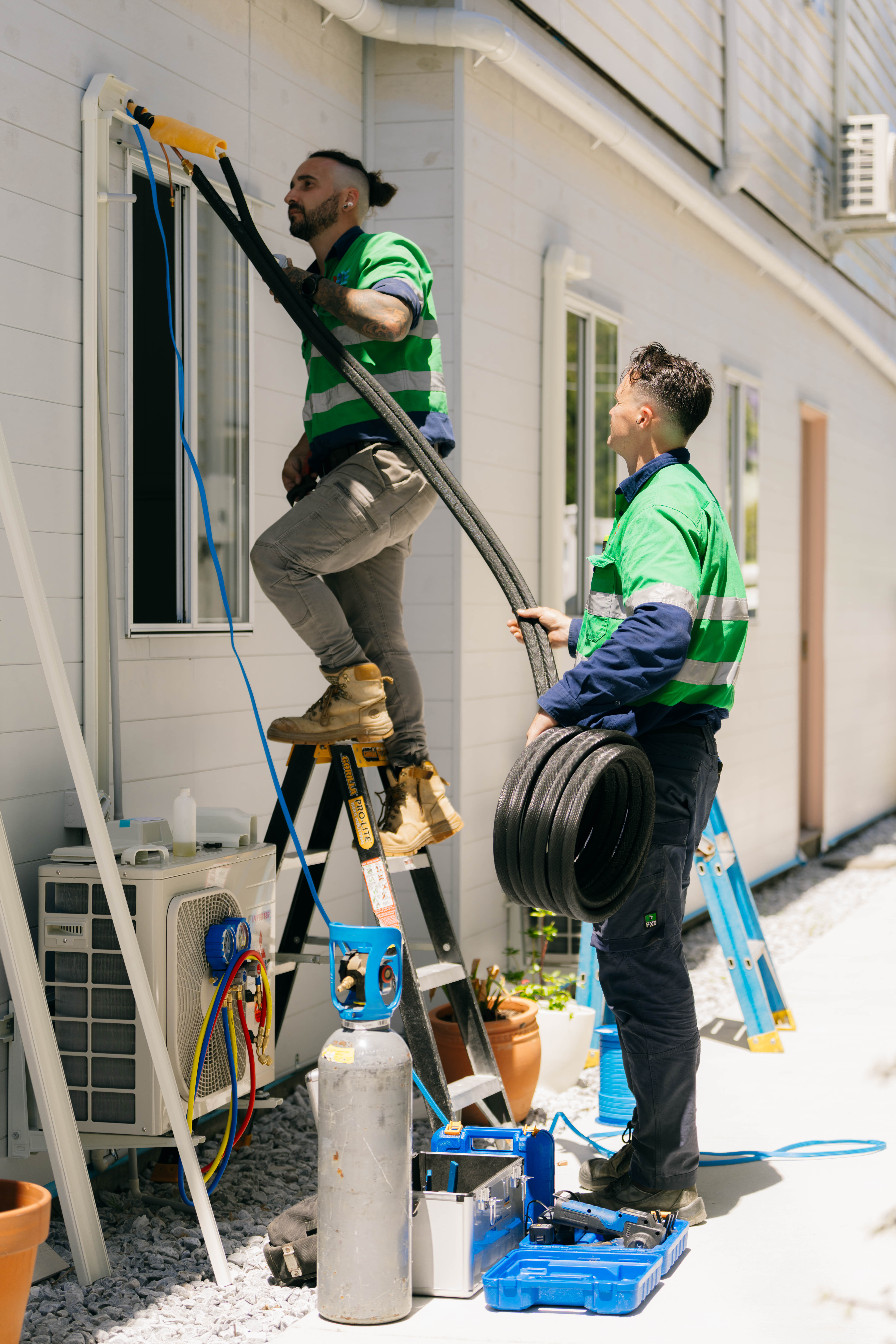Team installing air conditioning unit
